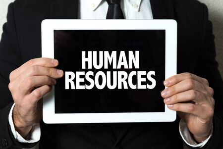 Person holding a tablet with Human Resourcesの写真素材