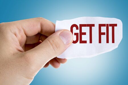 Person holding a piece of paper with the words Get Fitの写真素材