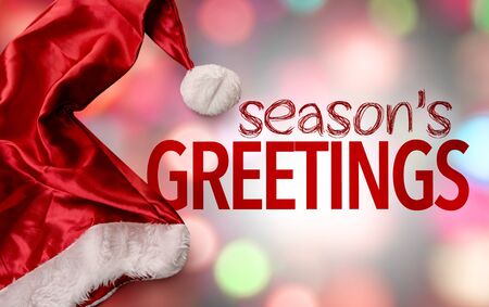 Santa hat with the words Season's Greetings on bokeh backgroundの写真素材