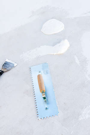 Construction and renovation materials. Steel straightener and spatula. Spacklingの写真素材