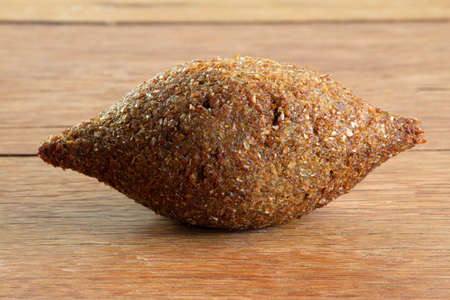 Kibbeh. Brazilian snack on the wooden table. Isolatedの写真素材