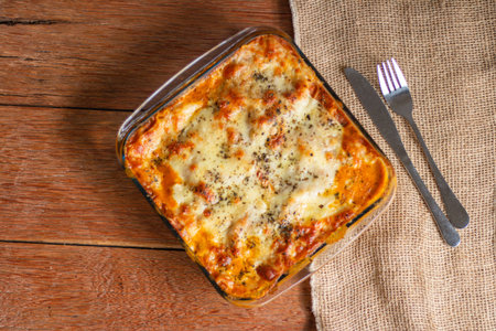 Traditional italian lasagna with cheese. On a wooden background