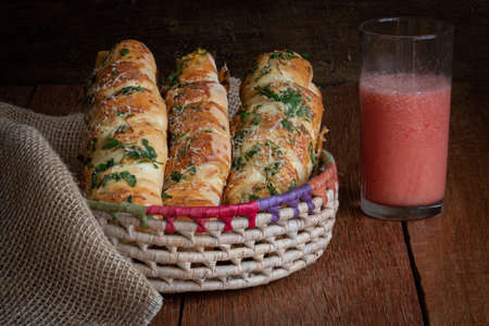 Bread stuffed with chicken and cheese and parsley on top. Wooden rustic backgroundの写真素材