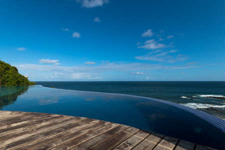 Infinity pool with views of the sea and blue skyの写真素材