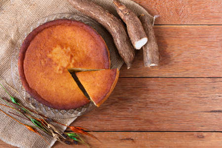 Cassava cake on wooden background. Cut piece. Top viewの写真素材