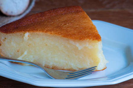 Cassava cake on wooden background. Cut pieceの写真素材