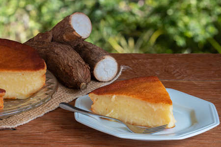 Manioc cake on wooden table with green background. Copy space.の写真素材