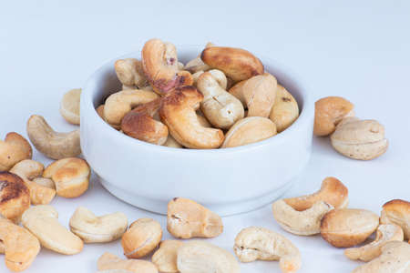 roasted cashew nuts in the bowl on white background.の写真素材