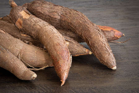 Fresh Cassava root with rustic wood background. Copy spaceの写真素材