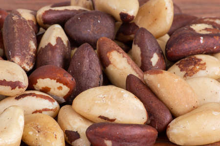 Brazilian nut, known as "Castanha do ParÃ¡". Wood backgroundの写真素材
