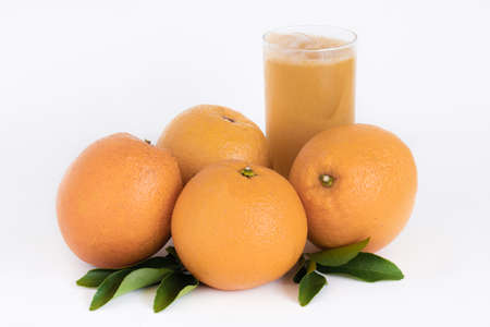 Ripe oranges isolated on the white background with glass of juice. Cut Path. Copy spaceの写真素材