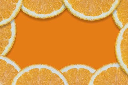 Oranges cut into pieces. Close-up texture. Copy space. Orange background