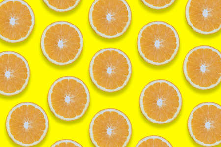 Oranges cut into pieces. Close-up texture. Copy space. Yellow background. Clipping Pathの写真素材