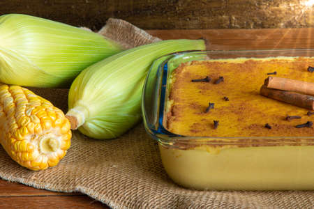 Hominy. Curau. Typical Brazilian junina party sweets. Corn cobs. Rustic wood background. Brazilian dessertの写真素材