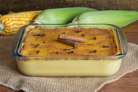 Hominy. Curau. Typical Brazilian junina party sweets. Corn cobs. Rustic wood background. Brazilian dessertの写真素材