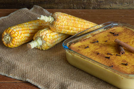 Hominy. Curau. Typical Brazilian junina party sweets. Corn cobs. Rustic wood background. Brazilian dessertの写真素材