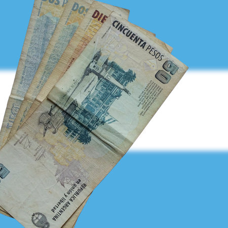 Argentine money. Banknote Argentine money. Isolated on background with blurred Argentine flag....