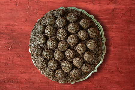 Brigadeiro cake. Traditional Brazilian sweet. Isolated on red background.Copy space
