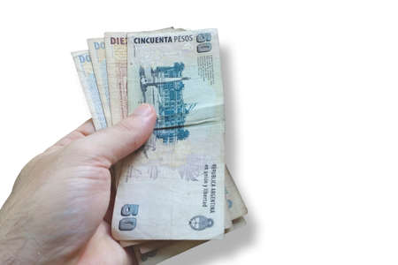 Man's hand holding Argentine money. Banknote Argentine money. Isolated on white background. Finance conceptの写真素材