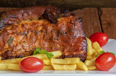 Juicy roast meat on a rustic wooden backgroundの写真素材