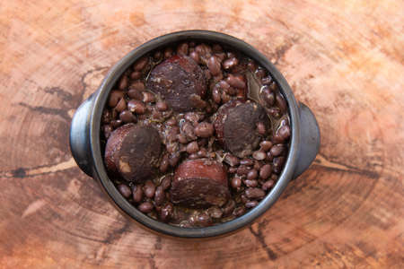 Feijoada. Traditional Brazilian food. Wood background. Top view. Copy spaceの写真素材