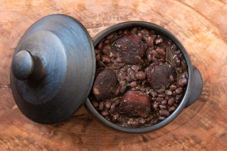 Feijoada. Traditional Brazilian food. Wood background. Top view. Copy spaceの写真素材