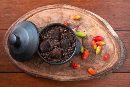 Feijoada. Traditional Brazilian food. Wood background. Top viewの写真素材