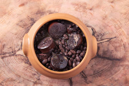 Feijoada. Traditional Brazilian food. Wood background. Top view. Copy spaceの写真素材
