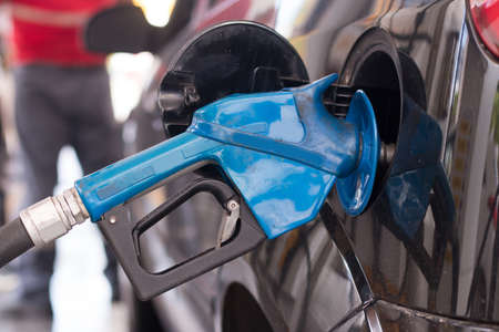 Doing supply with gasoline in vehicle in fuel station.の写真素材