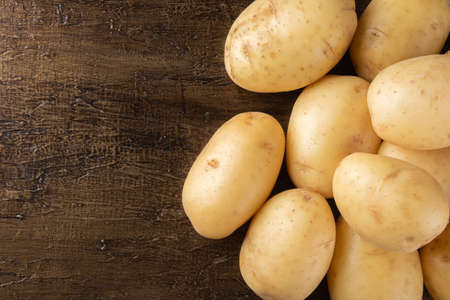 Pile of potatoes lying on rustic background. Top viewの写真素材
