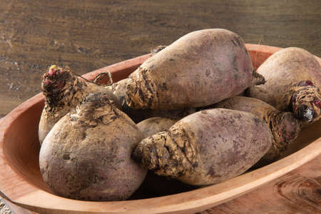 Pile of beets on wooden board and rustic backgroundの写真素材