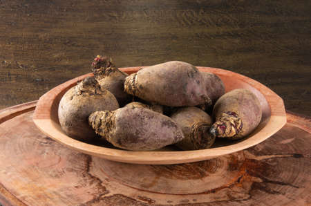 Pile of beets on wooden board and rustic backgroundの写真素材