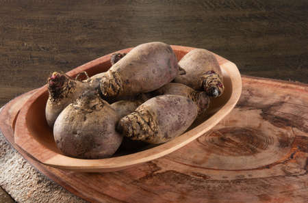 Pile of beets on wooden board and rustic backgroundの写真素材