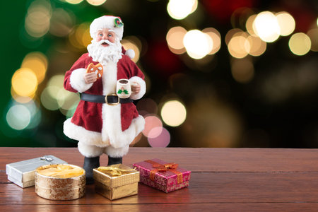 Christmas decoration.Santa Claus with gifts on a blurred Christmas background.