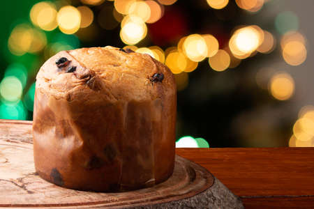 Panettone traditional Italian dessert for Christmas. Background with defocused lightsの写真素材
