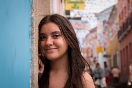 Lovely girl with dark-brown hair landing on the street.