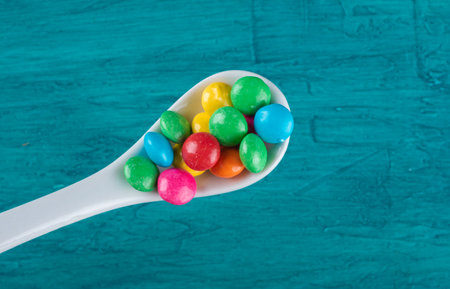 Colorful Confetti candy in spoon top viewの写真素材
