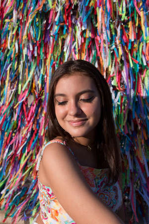 Girl in front of the grid with colored ribbons of Bonfim church in Salvador Bahia Brazil.の写真素材
