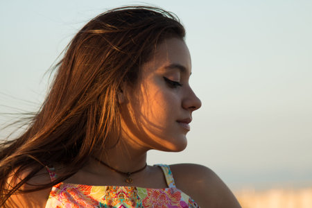 Portrait of girl outdoors with sunset light.