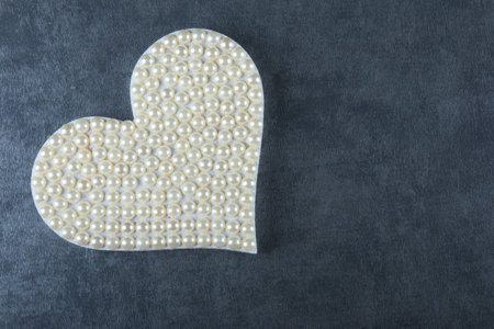 Valentine's day background with heart of pearls and gray backgroundの写真素材