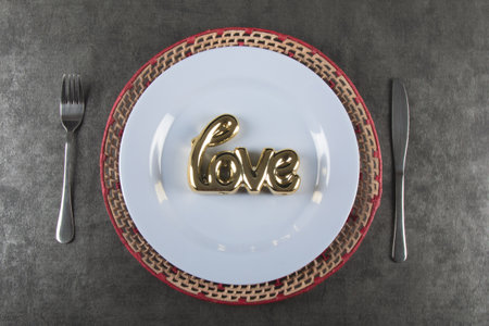 Valentine's day background with white plate with word Love top viewの写真素材