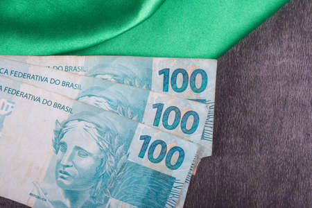 One hundred reais notes on Brazilian flag.の写真素材