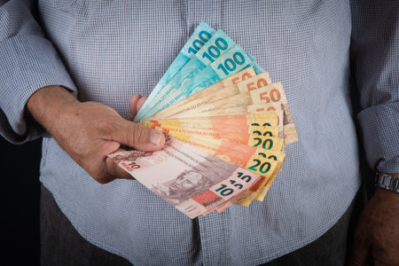 Man holding Brazilian money banknotes Finance concept.の写真素材