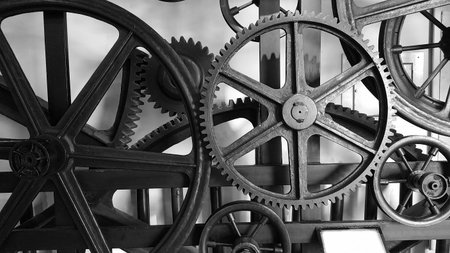 Detail of antique elevator metal gear wheel black and white.