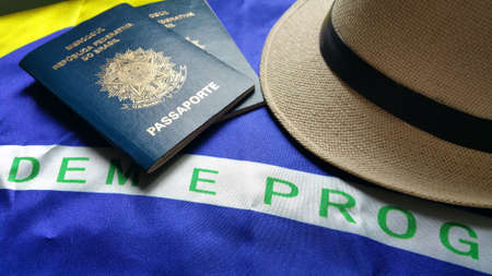 Brazilian passport with Brazilian flag in the background.の写真素材