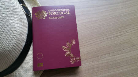 Portuguese passport on wooden table.の写真素材