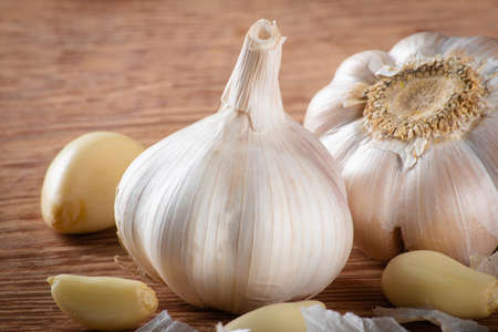 Garlic Cloves and Bulb isolated on wooden background..の写真素材