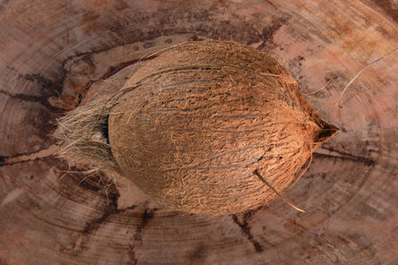 Dry coconut fruit isolated over rustic wood background..