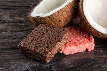 Coconut candy, sweet Brazilian in rustic wood background.