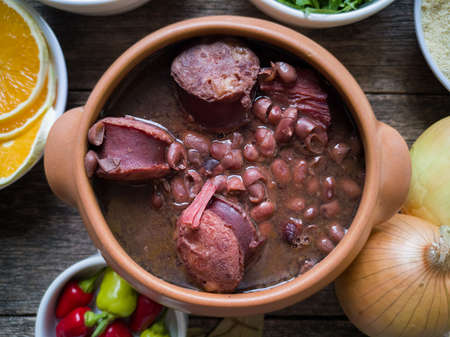 Feijoada in a ceramic bowl, traditional Brazilian food on a wooden background.の写真素材